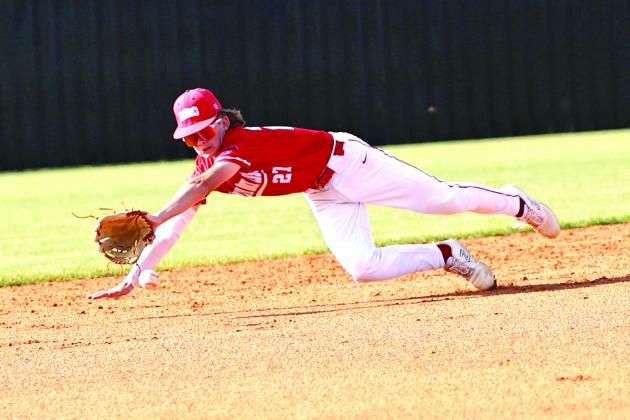 North Rock Creek’s Carson Wilbourn dives for a line drive in the game Monday, Mar. 27, against Perkins. The Cougars lost a close game 6-8. Photo courtesy of Gowin Photography