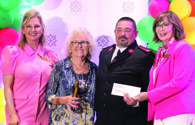 Sue Nelson, second from left, won the Michelle Briggs 'We're Here for Good' Service Award and chose the Salvation Army to receive the charity donation of $5000 that accompanied the award. Shown, during the Avedis Foundation Speaker Series Luncheon on May 28, from left, are Jill Spencer, Nelson, Salvation Army Captain Thomas Marion and Avedis CEO Dr. Kathy Laster. Photos by Natasha Dunagan, Countywide &amp;amp; Sun