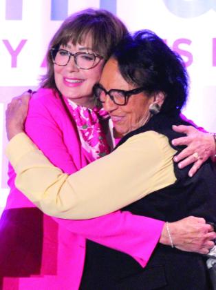 Avedis Foundation CEO Dr. Kathy Laster and Citizen Potawatomi Nation Vice-Chair Linda Capps share a hug after Laster presented a gift of appreciation to Capps at the Avedis Speaker Series Luncheon on May 28.