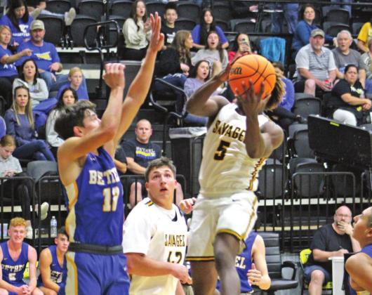 Tecumseh’s Daveon Mays makes a basket as Bethel’s John Gordon plays defense during the Tecumseh home game on Dec. 3. Bethel won 77-56. Countywide &amp;amp; Sun/Natasha Dunagan
