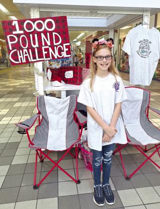 Bethel 4-H Vice President Ember Luna, 10, stands at a Shawnee Mall kiosk where she and her mother, Danielle Luna, took donations for her 1,000-Pound Challenge. They collected money and pet food donations to go towards the Shawnee Animal Shelter’s December Giveaway, benefitting the pets of those in need. Photo provided.