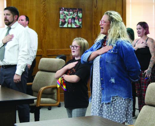 Shawnee fourth-grader Aurora Hall leads the Flag Salute next to Horace Mann Principal Jennifer Epperley during the Oct. 3 Shawnee Board of Education meeting. Countywide &amp;amp; Sun/Natasha Dunagan