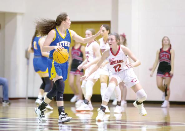 Bethel’s Parker Stevenson looks for someone to receive a pass during the Class 3A Area game, at Ada, against Comanche on March 5. The Bethel Lady Wildcats won 56-54 and advance to state on March 9.