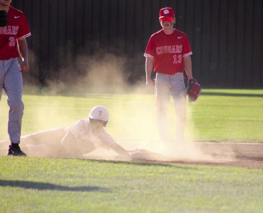 Tecumseh sophomore Elias Hasler dives back to second base, as North Rock Creek sophomore Drake Clemmons looks on, during the April 4 game at Tecumseh. The Savages lost, 0-3. Countywide &amp; Sun/Natasha Dunagan