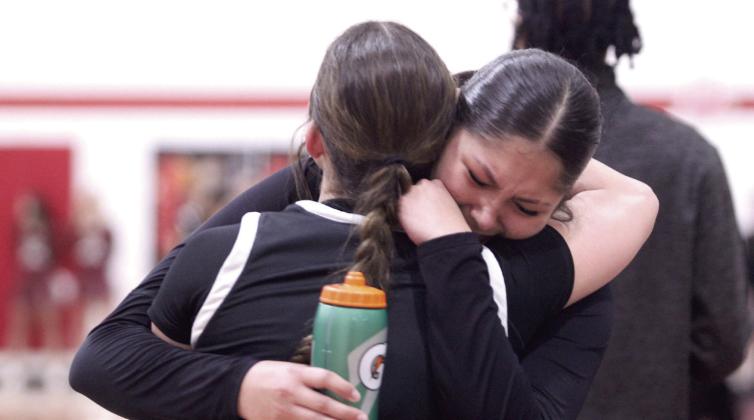 Cadence Leba and Genesis Fixico share a hug after the loss.