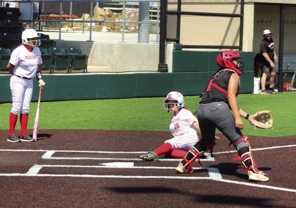 Macomb sophomore Lacie Lackey slides into home for a steal.