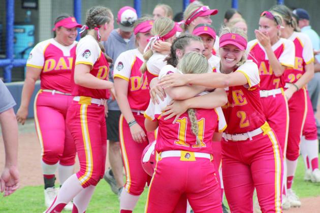 Three of the Dale Lady Pirates celebrate their Class 4A State Semifinals victory over Latta with a group hug on April 30. File photo