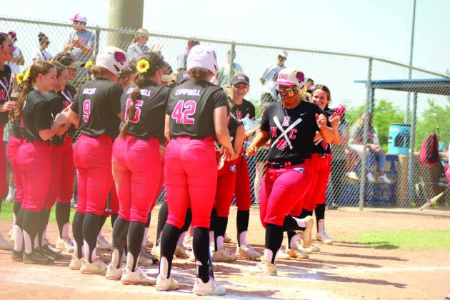 North Rock Creek’s Hannah Earlywine is congratulated for her home run in the second inning of the Class 5A Slow Pitch State Semifinals with Tecumseh on April 30. The #1-ranked Lady Cougars won in their Quarterfinals with Perkins-Tryon, 10-9, but lost to the #2-ranked Lady Savages in the Semifinals, 7-13. Their record this season is 33-9. file photo