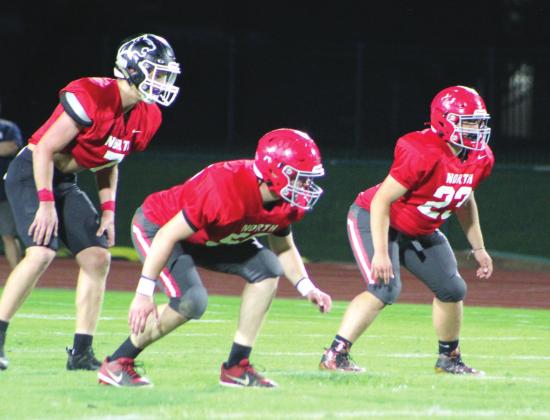 Colton Burch, second from left, and Jayce Williams, far right, both graduates of North Rock Creek, prepare for a play on the North Team during the Second Annual Citizen Potawatomi Nation All-Star Bowl, held at OBU on June 3.