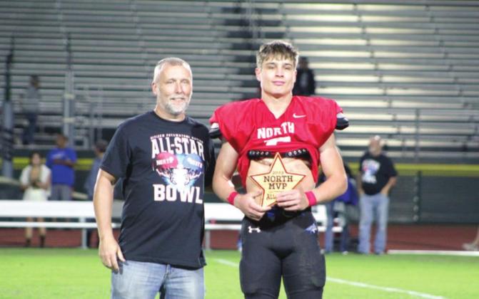Brian Parsons, of the Bethel Quarterback Club, presents the North Team MVP to Bridge Creek graduate Logan James following the Second Annual CPN All-Star Bowl on June 3 at OBU.