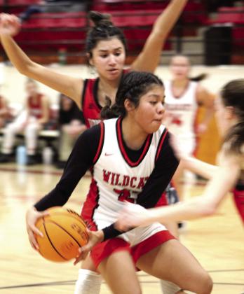 Earlsboro senior Chelsea Deere guards the ball on her way to making a basket during the fourth quarter of the Jim Walling Classic third-place game with Dover on Jan. 7. The tournament was held in Earlsboro, Jan. 5-7, and the Lady Wildcats lost, 40-47.