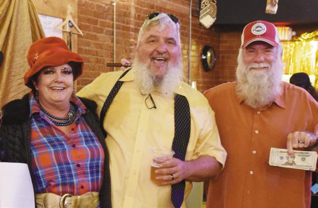 Rags 2 Runway Coordinators, Fran Topping and David Thomas, pose with Patrick Koch, VFW Commander, who received (on behalf of the VFW) the food donation portion of the funds raised by the event.
