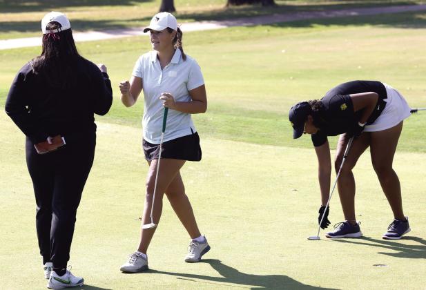 Oklahoma Baptist University senior Rylie Spaulding does a quick fist bump after a successful putt. Photo provided by OBU