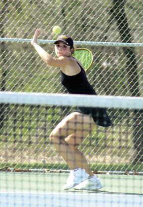 Tecumseh senior Kyann Sells watches the ball before returning it during the Tecumseh Tennis Tournament on March 30. Sells placed first in #1 Singles, and the Lady Savages tennis team placed first, out of eight teams.