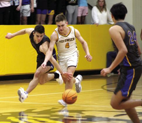 Bethel’s Bray Bussell tries for a steal as Tecumseh’s Brady Overstreet takes the ball down the court during the fourth quarter.