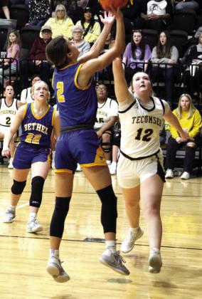 Bethel’s Baylee Tapley makes her shot, as Tecumseh’s Samantha Schweighardt guards, in the second quarter of the game at Tecumseh.