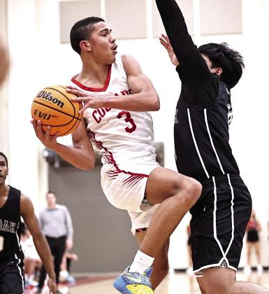 North Rock Creek's Tyson Hawkins drives the lane to pass the ball. NRC boys beat Crooked Oak 71-45. Photo Provided by Gowin Photography