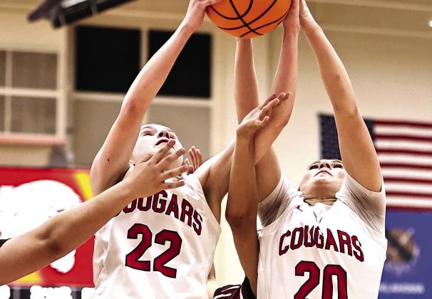 North Rock Creek's Kadence Munn and Aubree Shivelhood both go up for the rebound on Jan.6. Photo Provided by Gowin Photography