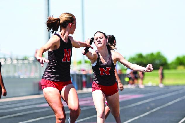 North Rock Creek's Peyton Lilley hands off to Abby Bloyed in the last leg of the 4x400m to win the event. Photo courtesy of Gowin Photography