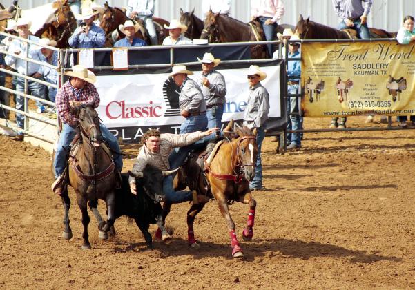 Dally Trussell, of McLoud, dismounts from his horse to grab a steer and wrestle it during the International Finals Youth Rodeo, at the Heart of Oklahoma Expo Center on July 9. Countywide &amp; Sun/Natasha Dunagan