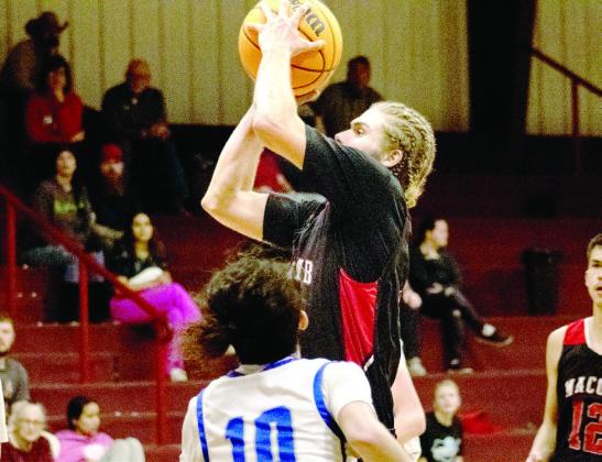 Macomb's Cobran Jones makes a jump shot.