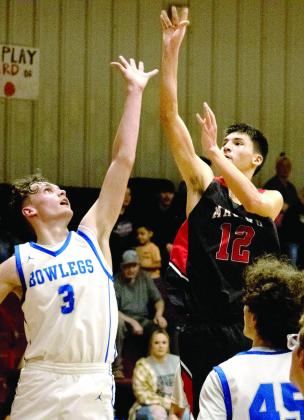 Macomb's Blayze Lewis puts up a shot over a Bowlegs defender at the Class B District Tournament against Bowlegs on Feb. 14 at Macomb. The Hornets lost, 35-47.