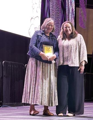 Project SAFE Director Renée Clemmons (pictured right) presents Jody Smith with the Purple Ribbon Award at the Honey Do Auction held Oct. 9, 2025 at The Grand Casino and Resort. Suzie Campbell, Countywide &amp; Sun