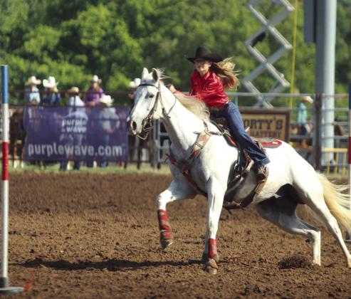 Kinzlee Jones of Shawnee concentrates on the next pole in the pole bending event of the International Finals Youth Rodeo on the morning of July 13.