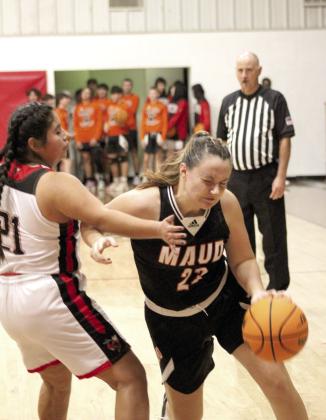Maud junior Kadie Jencik drives to the basket and is blocked by Macomb sophomore Yasmine Vance during the Macomb home game on Nov. 28.