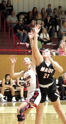Maud junior Jaycee Pack puts up a shot and is fouled by Macomb junior Brenna Beauchamp during the fourth quarter of the game at Macomb, Nov. 28.