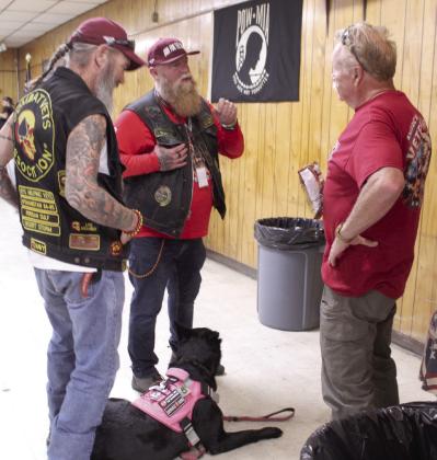 Navy veterans Mike Beauvais, of Tucson, AZ, and Paul Dussalt, of San Diego, CA, talk with local Air Force veteran Kirk Bertolet, as Bertolet's therapy dog Heidi lays between them.