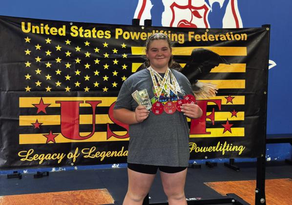 Colleen Williams, 12, of Dale, poses with her prize money and medals after breaking a world powerlifting record of a combined 742 pounds at the United States Powerlifting Federation competition in Denver, CO on Aug. 25. Photo provided.
