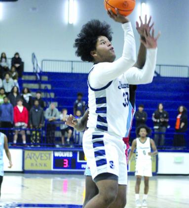 Shawnee sophomore Aidon Siqueiros makes a bucket in the home game against Western Heights on Dec. 12.