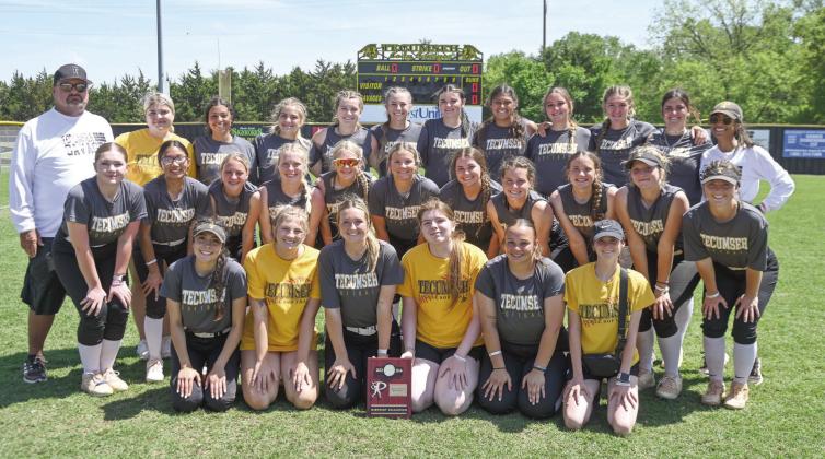 The Tecumseh Lady Savages and their coaches, Perry Wilson and Kayla Rodriguez, pose with their Class 5A District Slowpitch Softball Champion trophy on April 17. They beat Blanchard, 13-2; Crooked Oak, 15-0; and Blanchard, a second time, 10-3. The Lady Savages are scheduled to play in regionals at home today (April 25) at noon and 2:30 pm. Photo provided by Kenetta Lisenbee.