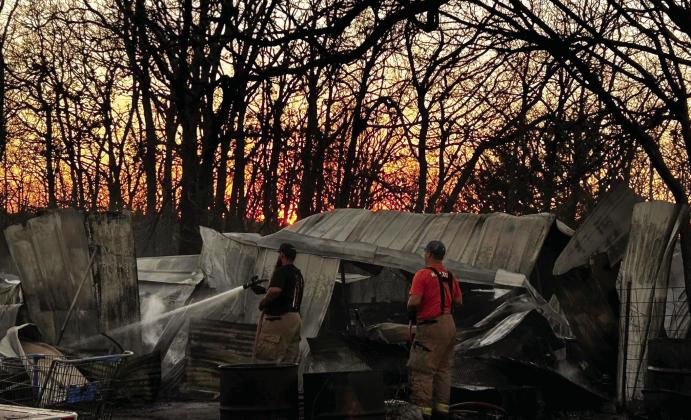 As the sun sets beyond the trees, Bethel Acres firefighters douse the hotspots of a fire on Dec. 22. With neighboring Fire Departments on scene including McLoud, Shawnee, and Tecumseh, the departments worked together to get the fire under control, saving the homes. Suzie Campbell, Countywide &amp; Sun