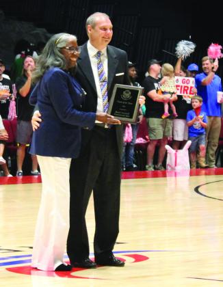 Potawatomi Fire Head Coach Mark Dannhoff accepts the Coach of the Year Award from The Basketball League CEO Evelyn Magley before the second Central Conference Regional game on June 19. Countywide &amp; Sun/Natasha Dunagan