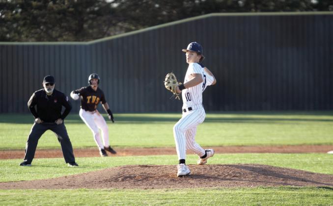 Shawnee's Derrock Criswell lines up his pitch in the bottom of the second inning during the Mar. 7 game at Tecumseh, as a Savage runner tries to steal third. Tecumseh won, 7-5. Natasha Dunagan, Countywide &amp; Sun