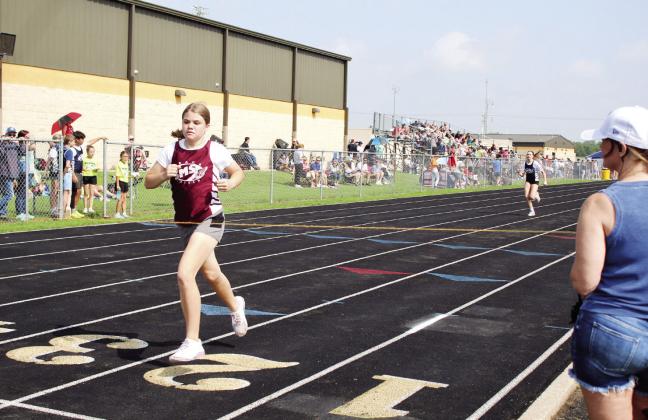 Shawnee Middle School student Riley Chamblin crosses the finish line first in the sixth-grade girls 400 meter race during Little Olympics at the Tecumseh High School track on March 12. Ten Shawnee area schools' fourth- through sixth-graders participated in the event, which was moved due to tornado damage at Shawnee High School. Countywide &amp; Sun/Natasha Dunagan