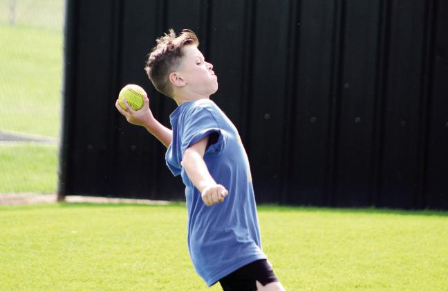 Sequoyah Elementary fourth-grader Carson Hutchcraft winds up for the softball toss during the Kiwanis Club's Little Olympics on March 12. The event was held at the Tecumseh High School track this year, due to tornado damage at Shawnee High School's Jim Thorpe Stadium. Assistant Scorekeeper Erika Jones said there has only been one other time in Little Olympic's 90 years that it was held at a different location, and that was at OBU. Countywide &amp; Sun/Natasha Dunagan