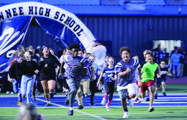 Students from Sequoyah Elementary run out of the tunnel before the Wolves football team at the Oct. 23 homecoming game against Tulsa's Edison Prep. Four students from Sequoyah were also honored during the game for perfect attendance.