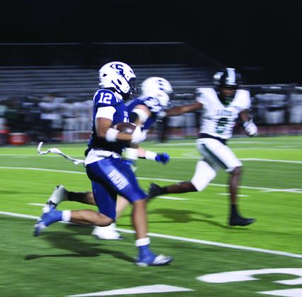 To open their homecoming game on Oct. 23, Shawnee senior Dillion Simmons caught the kickoff return and made a 95-yard touchdown run in 10.2 seconds. Photos by Natasha Dunagan, Countywide &amp; Sun