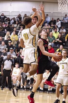 NRC’s Kohen Warden goes between two defenders to score.