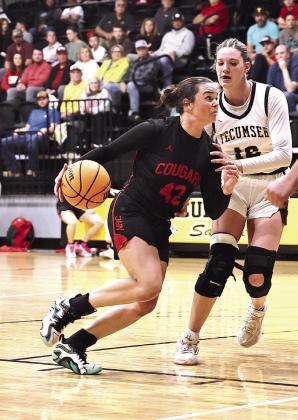 NRC’s Sarah Campbell drives towards the basket around Tecumseh’s Kaydee Lewis. The Lady Cougars came up short with the Lady Savages, losing 36-32.