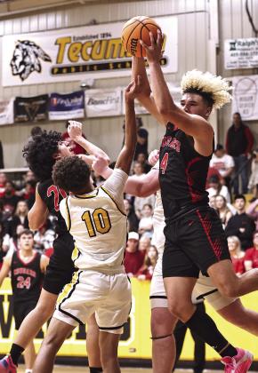 NRC’s JJ McClain goes up high for the offensive rebound against Tecumseh’s Jekhi Owens.