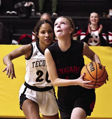Addisen Lawrence drives past Aaliyah Stargell to score.
