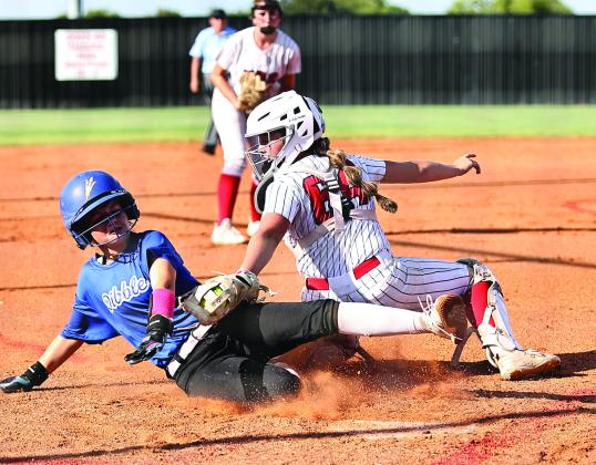 North Rock Creek’s Ashlyn Bade tags the Dibble runner at home.