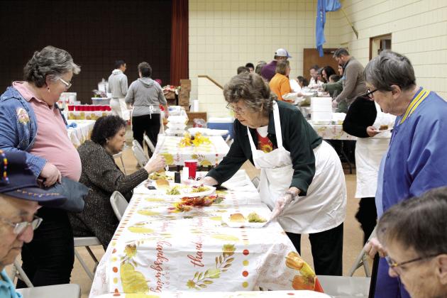Almeda Dyer, age 91, serves Jean Cutting, left, and Claudia Rice during the 17th Annual Tecumseh Family Thanksgiving Dinner, held at the Tecumseh City Hall Auditorium on Nov. 24. Dyer said she usually volunteers at the Golden Age Senior Center and plans to walk in the upcoming Grinchmas parade. Also shown is Dr. Carol Crouch, second from left, who is a tribal liaison with two groups who have sponsored the meal for nine years. Countywide &amp;amp; Sun/Natasha Dunagan