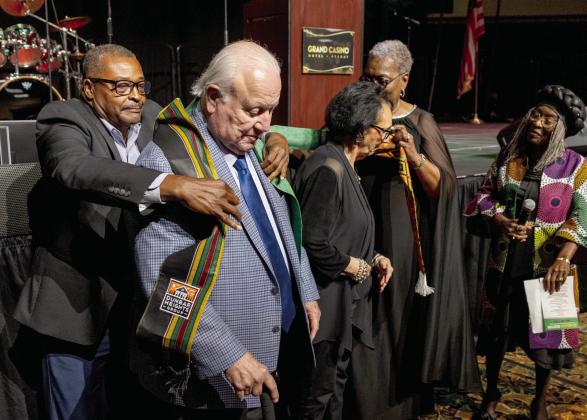 Citizen Potawatomi Nation (CPN) Chairman John 'Rocky' Barrett and Vice Chairman Linda Capps are honored with scarves by Dunbar Heights Group President Timmy Young and Gloria Wallace, as Dunbar Heights Board Member Marie Tubbs watches, at the CPN and Dunbar Heights Group Juneteenth VIP Reception, held at the Grand Casino Hotel and Resort on June 12. Capps was also recognized as Woman of the Year at the event.