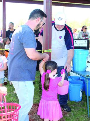 Tecumseh First Assembly of God Pastor Don Jonker hands out prize eggs to each child who participated in the Tecumseh EGGsperience and Block Party on April 8. The egg could be redeemed for a variety of prizes, such as candy, restaurant gift certificates or toys. Jonker said they had 300 prize eggs and ran out with the last age group. However, they were still able to claim a prize.