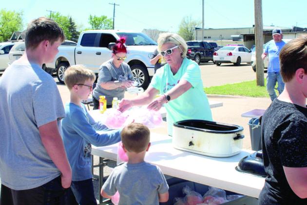 Dana Montgomery, a volunteer with Tecumseh First Assembly of God, hands out cotton candy. They had 500 hotdogs and 200 bags of cotton candy ready to give away.